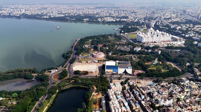 Drone footage capturing Hussain Sagar, nearby landmarks, green spaces, and urban neighborhoods blending into Hyderabad&rsquo;s expansive skyline.