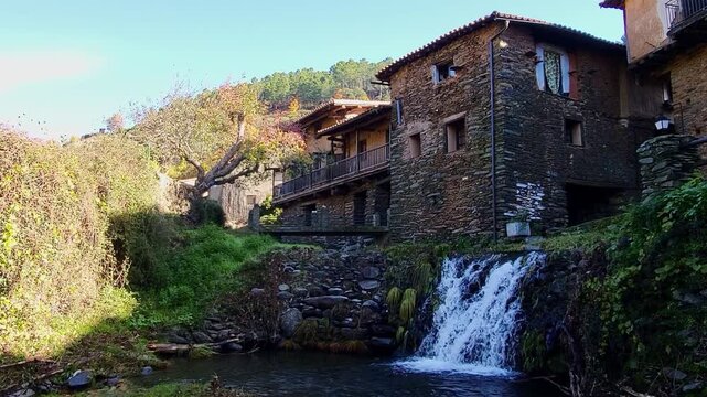 Robledillo de Gata. Spain. Panoramic view. Beautiful mountain village with stone and slate buildings. Waterfall next to picturesque stone and slate houses. C&aacute;ceres.