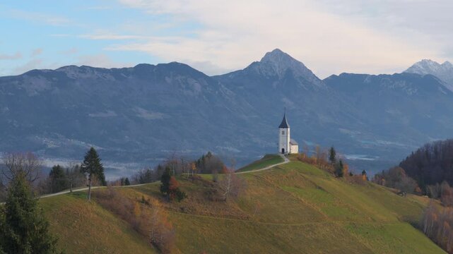 Famous Jamnik Church on hill with mountains in Slovenia scenic landscape view