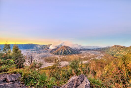 Sunrise, smoking volcano Mount Bromo, Mt. Batok at front, Mt. Kursi at back, Mt. Gunung Semeru, Bromo Tengger Semeru National Park, Java, Indonesia