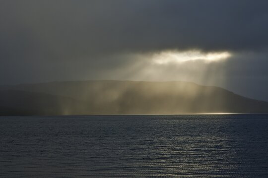 Gap in the clouds with sun shining through, Patreksfjoerdur Fjord, Westfjords or West Fjords, Iceland, Europe