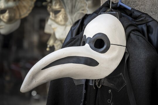 Venetian carnival mask, plague doctor, in a shop window, Venice, Veneto, Italy