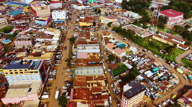 Aerial flyover poor Kitale Slum and modern skyline of Kitale rural urban area of kenya during sunny day. Two class society in Africa.