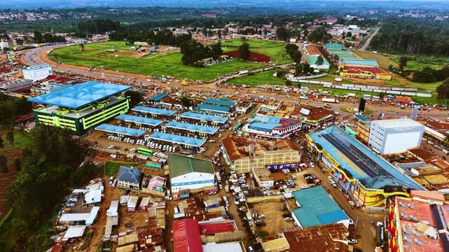 Aerial flyover poor Kitale Slum and modern skyline of Kitale rural urban area of kenya during sunny day. Two class society in Africa.