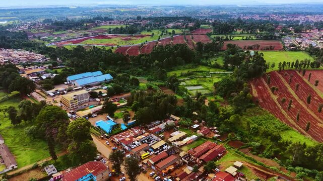 Aerial flyover poor Kitale Slum and modern skyline of Kitale rural urban area of kenya during sunny day. Two class society in Africa.