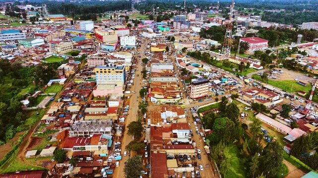 Aerial flyover poor Kitale Slum and modern skyline of Kitale rural urban area of kenya during sunny day. Two class society in Africa.