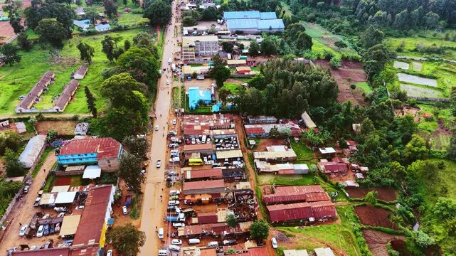 Aerial flyover poor Kitale Slum and modern skyline of Kitale rural urban area of kenya during sunny day. Two class society in Africa.