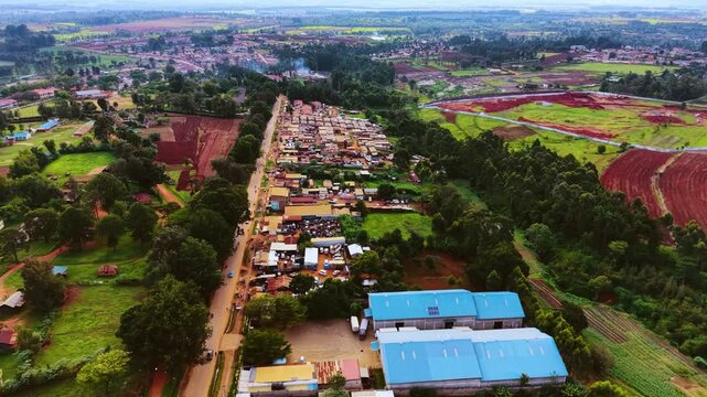 Aerial flyover poor Kitale Slum and modern skyline of Kitale rural urban area of kenya during sunny day. Two class society in Africa.