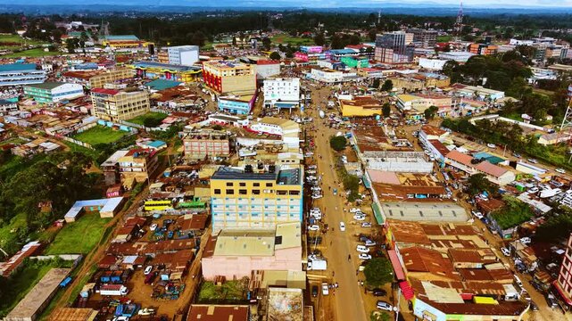 Aerial flyover poor Kitale Slum and modern skyline of Kitale rural urban area of kenya during sunny day. Two class society in Africa.