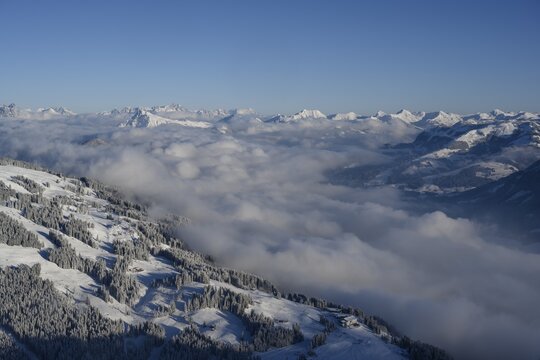 View from the summit of the Hohe Salve to the Brixenthal with Kitzb&uuml;hler Horn, clouds in the valley, Kitzb&uuml;heler Alps, Tyrol, Austria