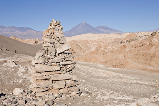 Cairn and the Licancabur Volcano (5920 m or 19422 ft) viewed from the Valle de la Muerte (Death Valley or sometimes called Martian Valley), San Pedro de Atacama, Regi&oacute;n de Antofagasta, Chile, South America