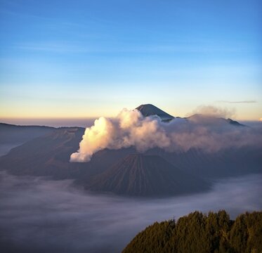 View of volcanoes at sunrise, smoking volcano Gunung Bromo, Batok, Kursi, Gunung Semeru, Bromo-Tengger-Semeru National Park, Java, Indonesia