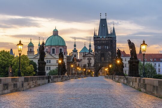 Karlův most, Charles Bridge at dawn, dome of the Church of the Holy Cross, Charles Bridge with Old Town Bridge Tower, Prague, Bohemia, Czech Republic