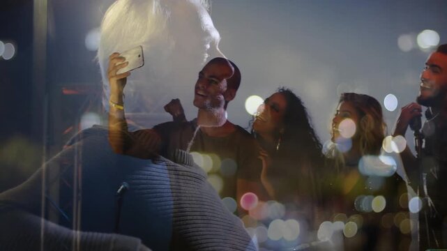 Phone-holder raising smartphone, friends celebrating and checking screen amid overlay show profile