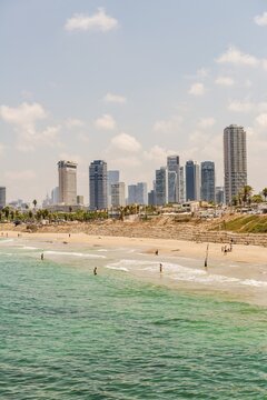 People on the beach, Alma Beach, view of skyline of Tel Aviv with skyscrapers, Tel Aviv, Israel