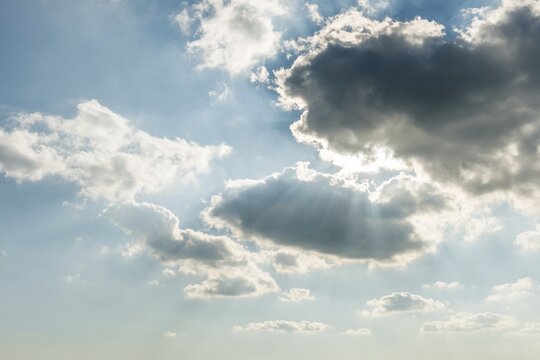 Sun shines behind dark clouds, Germany