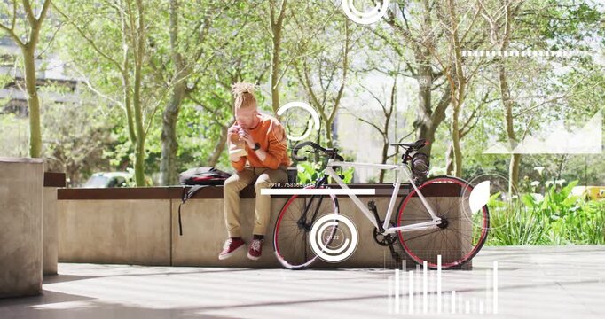 seated man tapping phone, activating AR technology graphics over bicycle, reviewing ride metrics
