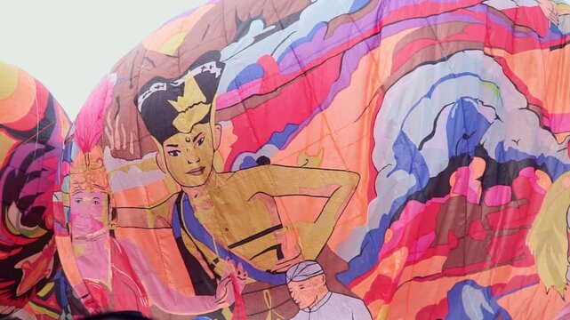 Colorful hot air balloons with vibrant patterns floating in the sky, showcasing festival atmosphere and outdoor adventure travel concept. Wonosobo balloon festival, Indonesia.