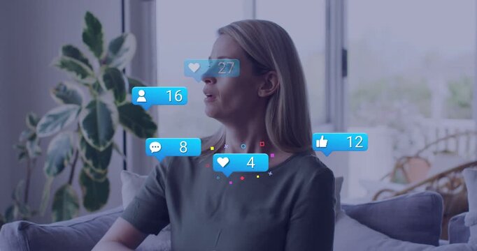 Woman on sofa glancing out, heart or like or comment or follower rising, covering mouth, boosting ma