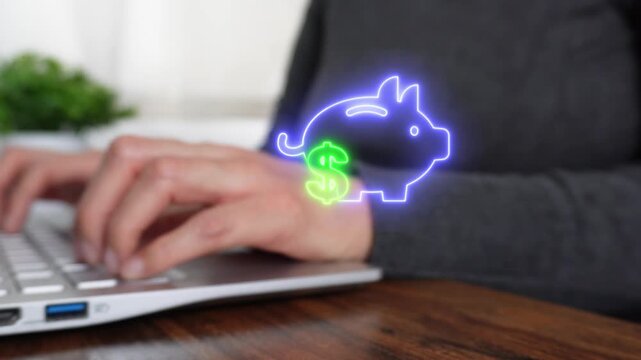Accumulation of money and capital. Close-up of a woman's hand working on a computer while pointing to a virtual piggy bank icon and money sign.