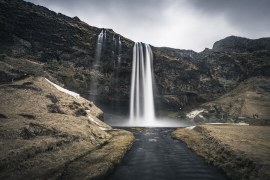 Dark atmosphere, waterfall Seljalandsfoss, river Seljalandsa, Southern Region, Iceland