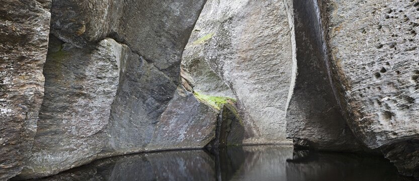 Rocks reflected in a pond in Vetlahelvete Cave, Aurlandsdalen Valley, Norway, Scandinavia, Europe
