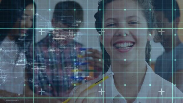 Vertical video: Smiling teen holding pencil camera pulling HUD overlaying peers making blocks STEM