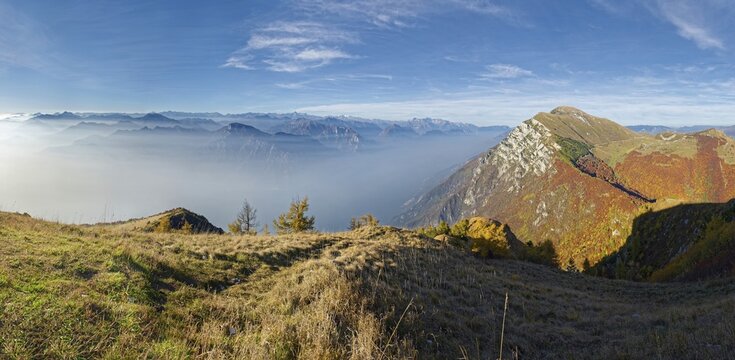 Northern Lake Garda in the morning mist with the peaks Monte Altissimo de Nago, Monte Baldo, Malcesine, Verona Italy, Trentino-Alto Adige, Italy