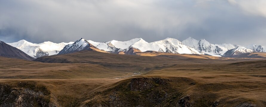 Glaciated and snow-capped mountains, dramatic landscape, high plateau, autumnal mountain landscape with yellow grass, Tian Shan, Sky Mountains, Sary Jaz Valley, Kyrgyzstan