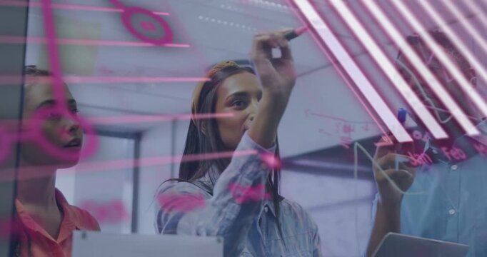 Vertical video: After marker pickup lead woman in denim drawing on glass in office with pink charts
