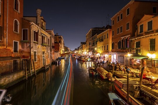 Canal with boats and historical buildings, light traces, Venice, Veneto, Italy