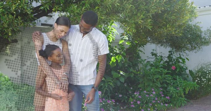 Mother hugging daughter after dotted overlay sweeping frame, father resting arm by tree, for health