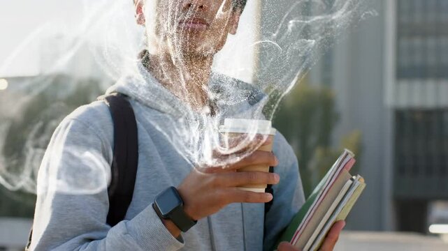 Vertical video: Steam bursting from cup, man in gray hoodie holding notes, sipping coffee at plaza
