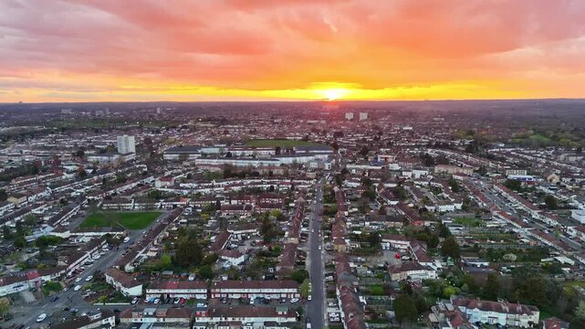Aerial view over Enfield, London, a suburban neighborhood at sunset with orange clouds in the sky
