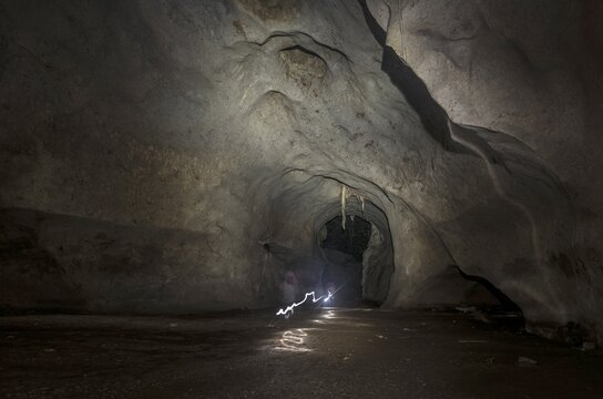 Hikers, tourists walking through a cave with a torch, Kuala Tahan, Taman Negara National Park, Malaysia