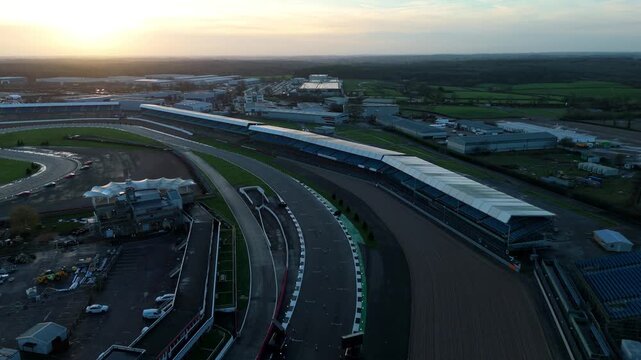 Drone view of a legendary British Motorsports venue at Silverstone featuring the track and facility at sunset in the winter season.