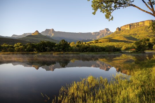 Sunrise, amphitheatre with reflection in the lake, Royal Natal National Park, Drakensberg Mountains south, Kwa Zulu Natal, South Africa