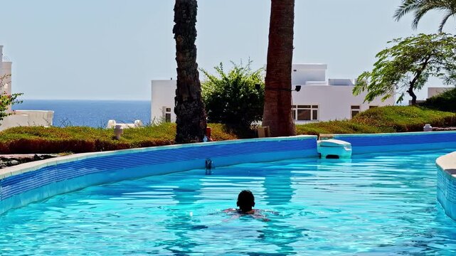 A woman swims at a luxury resort in Sharm El Sheikh