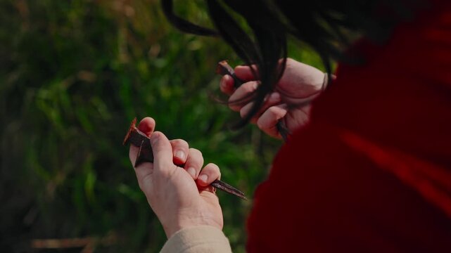 closeup of open hands of Jesus Christ holding four rusty iron crucifixion nails
