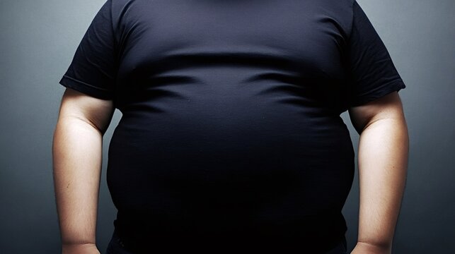 Overweight man showing body fat in black t shirt