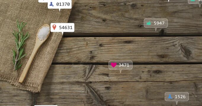 Rustic tabletop showing wooden spoon holding coarse salt and rosemary sprig with social media icons