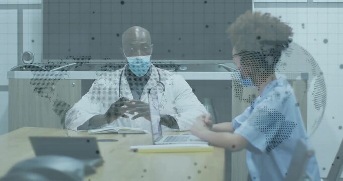 Nurse reviewing charts in hospital while doctor explaining patient case with world map projecting