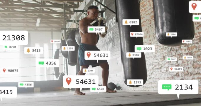 Male athlete lifting knee to brace bag, training boxing while animated pins tracking progress