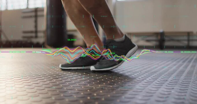 Male athlete hopping on gym floor, waveform overlay peaking with each foot strike during training