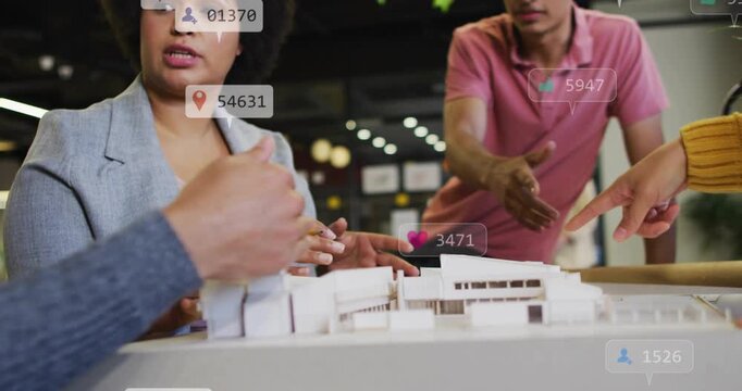 Woman architect pointing pencil at model while team pointing, icons multiplying and shaping design