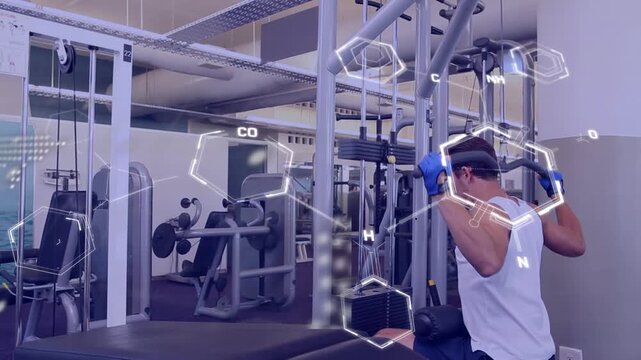Animation of data processing over caucasian man exercising at gym