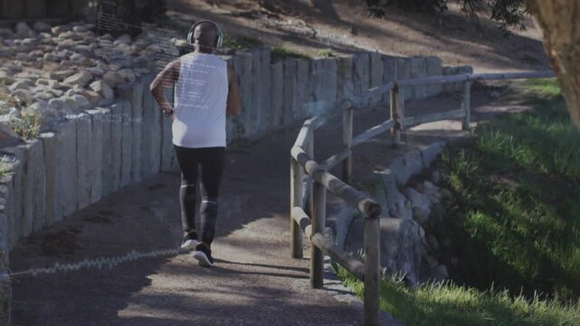 Crunching gravel initiating floating pace graph above runner moving along trail, tracking fitness