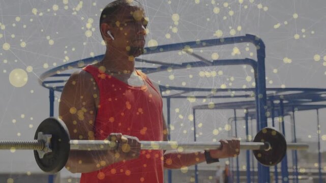 Midadult man gripping barbell at chest, doing curls for training with gold dust over scene, pausing