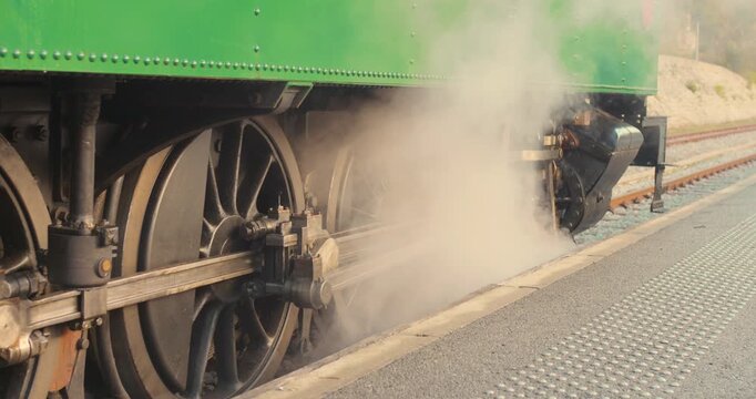 Wheels of a steam train stopped at the station. Close up