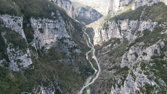 Aerial drone footage over Frasassi Gorge, Italy: rocky cliffs, green vegetation and dramatic natural landscape. Ideal for travel, nature and geological projects.